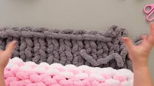 You can also easily add color interest by using variegated yarn. How To Hand Knit A Blanket With Jumbo Chenille Three Colors Youtube Arm Knitting Blanket Hand Knitting Diy Hand Knit Blanket