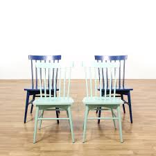 This Set Of Spindle Back Dining Chairs Is Featured In A Solid Wood With A Mint Green And Navy Blue Paint Finish Each Side Chair Chair Dining Chairs Furniture