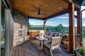 This home offers plenty of luxurious amenities including custom millwork, hand hewn timber framing, log posts and reclaimed wood beams. Western Montana Custom Home Outdoor Stone Firplace Kitchen Cabinets Timber Frame Tongue Groove Porch Compsite Decking Clearwater Builders Of Montana