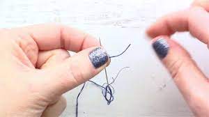 Take your needle and thread from the back to the front of the fabric, like you normally would, only don't pull all the way through. How To Tie Knots In The End Of Embroidery Floss With A Quilter S Knot Youtube