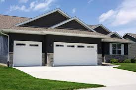 Garage doors include hand forged wrought iron custom hardware Overhead Door Traditional Steel Garage Doors Sales Installation