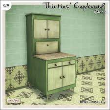 French tiles create a colorful backsplash above a hospital sink set among an antique desk and aged office hutch that now holds cups. Second Life Marketplace V W Vintage Thirties Cupboard Green 2 Li Classic Old Kitchen Furniture