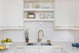 An elegant white marble kitchen and large marble backsplash under the stylish hooded range brighten up this beautiful kitchen. Best Quality Mosaics In New York Home Art Tile Herringbone Backsplash Herringbone Tile Backsplash Herringbone Backsplash Kitchen