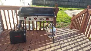 This compact camping stove features three burners and a grill top for easy cooking. Tundra 3 Burner Stove Camp Chef