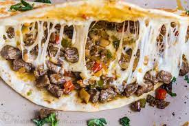 Philly cheesesteak meets quesadillas when steak, bell peppers, onions, and cheddar cheese are baked between tortillas. Philly Cheesesteak Quesadilla Recipe Natashaskitchen Com