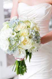 The bold combination of navy blue and yellow perfectly compliments a rustic or barn summer wedding. Light Blue Hydrangeas Pale Yellow Roses And White Lisianthus Bouquet Yellow Wedding Flowers Yellow Bridal Bouquets Yellow Wedding Bouquet