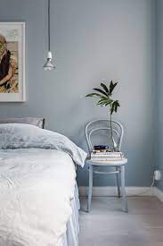 For a contemporary bedroom, wall lights in an interesting but classic shape, like torches, can look great. The Designer S Small Space Trick That Makes Any Room Look Larger Bedroom Wall Colors Blue Bedroom Walls Bedroom Interior