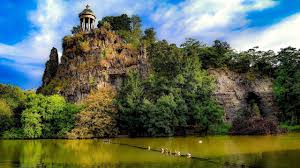 A bare hill, half hollowed out by abandoned tunnel quarries and filled with the. A Walk Around Parc Des Buttes Chaumont Paris Youtube