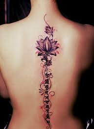 This multicoloured floral spine tattoo in shades of pinks, purples, yellows and greens is a beautiful, artsy, feminine design for all the flower lovers out there. 25 Purposeful Spine Tattoo Designs For Women And Girls