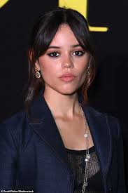 Jenna Ortega looks chic in a navy blazer and pleated skirt as she's seen  dancing at the Dior show during Paris Fashion Week