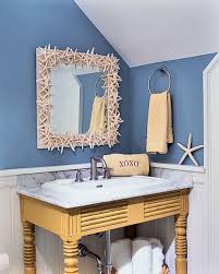 You can use shells that you have found in your beach travels or purchase a bag of shells at a craft store. Good Looking Boston Seashell Wall Decor Bathroom Beach Style Bathroom White Wood Mirror Sloped Walls Marble Countertops Blue Wainscoting