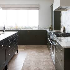 A high gloss grey kitchen boasts minimalism with a light and spacious feel. Plain English Kitchen Hammersmith Mews