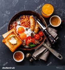 English Breakfast In Cooking Pan With Fried Eggs Sausages Bacon Beans Toasts And Coffee On Dark Stone Background Cafe Food Cooked Breakfast Food