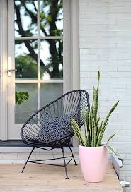In This Understated Back Porch Setting The Acapulco Chair Flies Under The Radar As This Pretty Pastel Plante Front Porch Decorating Porch Chairs Small Porches