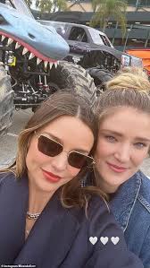 Miranda Kerr gets dirty as she attends a monster jam event with her sons