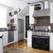 More than that, the hood extends on one side and its surface can be used as a shelf. Exposed Kitchen Hood Vent Design Ideas