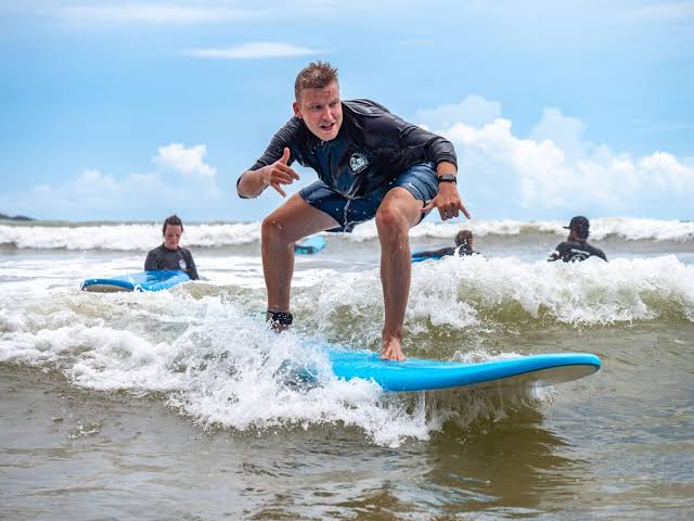 Weligama Bay surf beginner waves Taprobane Island town seafood south coast 25km east Unawatuna Sri Lanka