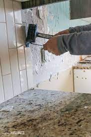 Start prying off the tiles, one by one, working with a hammer and chisel to lift up each tile. Tile Removal Kitchen Backsplash Part 1 Making Manzanita