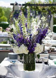 10 Summer Centerpieces To Brighten Up Any Table Fiftyflowers Hydrangeas Wedding Wedding Flowers Summer Wedding Flower Arrangements
