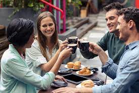 Friends having coffee together Stock Photo by ©Wavebreakmedia 101092312