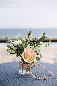 The mason jar diy project involves gluing faux beach glass around a mason jar. 30 Amazing Beach Wedding Centerpieces To Get Inspired Chicwedd