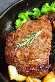 A Traditional Rib Eye Steak In A Cast Iron Pan After Being Pan Seared With Broccoli And Sauteed Potatoes On The Beef Recipes Ribeye Steak Recipes Ribeye Steak