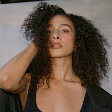 Netflix's Aurora Perrineau Shares the Secrets to How She Learned to Embrace  Her Curly Hair