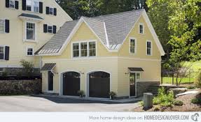 Behind a black door of a yellow house. 20 Traditional Architecture Inspired Detached Garages Home Design Lover Yellow House Exterior Garage Door Design House Paint Exterior