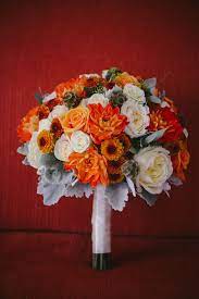 Real flower bouquets should be made very close to the wedding day and stored in water. Fiery Orange Bouquet For A Walt Disney World Bride Flower Centerpieces Wedding Flowers Bridal Bouquets Beautiful Wedding Flowers