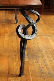 A wrought iron coffee table with glass top. Hand Forged Table Leg Detail Wrought Iron Table Iron Table Legs Iron Furniture