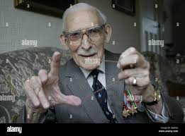 Former Japanese prisoner of war Fred Ryall at his home in Wembley, north  London. Holding the tiny piece of string he tied around his waist as an  emaciated Japanese prisoner of war