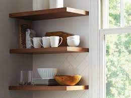 Storage stand with dishes and glassware near color wall. How Floating Shelves Are A Great Interior Design Solution Talie Jane Interiors