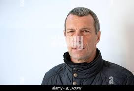 Stuttgart, Germany. 23rd Mar, 2020. Kevin Mayle (r), who is doing a  voluntary social year at the Olga 46 homeless shelter, slips a packed lunch  over a table to a visitor to