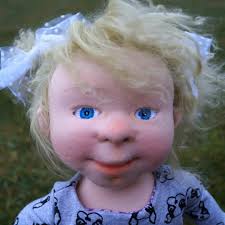 Sophie A girl with large blue eyes embroidered with silk thread. Her height  is 40 cm. The doll girl has a cotton dress buttoned at the back. A velour  sweater and shoes.