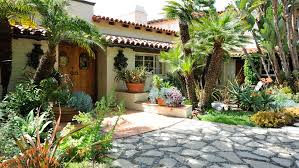 Welcome to the hacienda siesta alegre, where tropical breezes and lush landscaping welcome you. April Palmer Landscape Design Spanish Hacienda