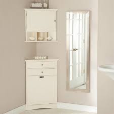 Set up a white cabinet, filled with fresh bath linens, next to the laundry hamper. Corner Bathroom Floor Cabinet Corner Bathroom Floor Cabinet Design