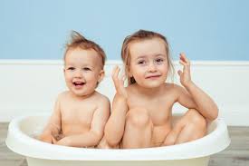 A parent's guide wonder how to do a baby bath? Premium Photo Baby Bathing And Hygiene Care For Young Children Two Cheerful Sisters Bathe In A White Baby Bath And Play Among The Soap Suds