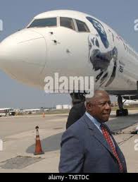 Hank Aaron, Major League Baseball's home run king and Hall of Famer, with  his wife, Billye, poses next to a Delta Air Lines Boeing 757 aircraft  bearing his likeness to honor his