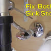 Unthread the sink stopper's tailpipe from the underside of the drain. 1