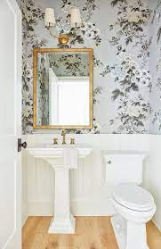 Welcoming Luxurious Powder Room Is Fitted With A Pedestal Sink Fixed To A Rustic Wood Floor And Matched Wi Bathroom Wallpaper Bathroom Decor Powder Room Small