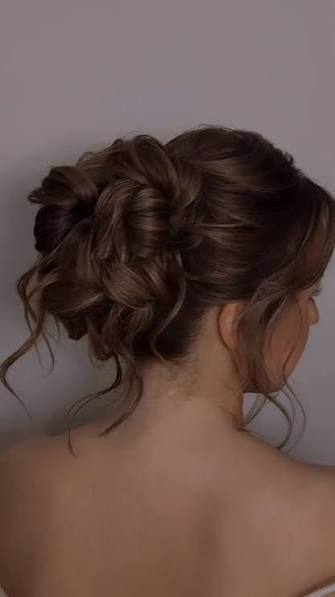 Low Bun Hairstyle With Face Framing Tendrils