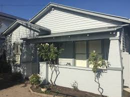The californian bungalow became the most popular style for housing, using pale colours such as off whites, buffs and creams for the body of the house and dark greens, dark reds and even blacks for trim and shingles under the gables and bay windows. Californian Bungalow Thornbury M J Harris Painting