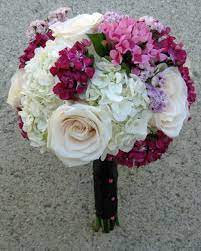 A bridal bouquet on a purple wedding doesn't necessarily have to be monotone. Bright Summer Wedding Floral Design By Jacqueline Ahne S Blog