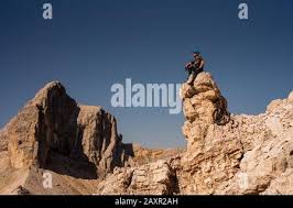 The well-known alpine unicyclist Michael Rung in the Karwendel mountains at  over 2300 m height with his unicycle Stock Photo