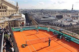 French Tennis Players Jo Wilfried Tsonga L And Richard Gasquet R Play On A Roof Top Clay Court On Tennis Court Design Tennis Lessons French Tennis Players