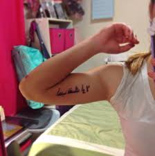 Words 'love yourself first' inked in a handwritten font on the left forearm related tattoos. Love Yourself First Fudo Ink