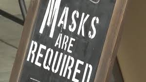 People with no masks pose for photos in times square in the manhattan borough of new york city on may 14, 2021. Mask Mandates Make A Return Along With Controversy The Washington Post