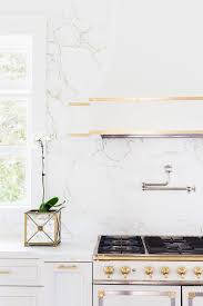 Polishing white quartz stone tiles for quartz kitchen countertops. Alyssa Rosenheck White And Gold French Kitchen Hood And Stove With White Quartz Marble Like Countertops
