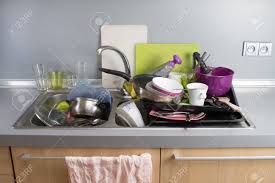 dirty dishes in a kitchen sink. stock