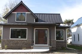 Metal roof on grey siding home. Residential Culpitt Roofing